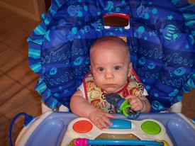 Tue Oct 25 19:26:19 2005

I sit in my high-chair, by dad, each night while he and Mom have dinner.  Some nights I get a treat, too.  This night I had a baby cookie in my chew net.