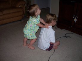 Wed 13 Oct 2010 07:23:49 PM

Gracie bugs Andrew while he tries to play a Playstation game.